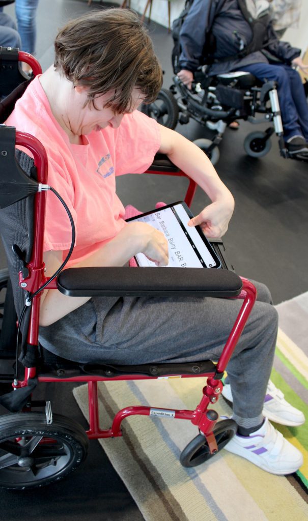 A woman using a tablet to communicate