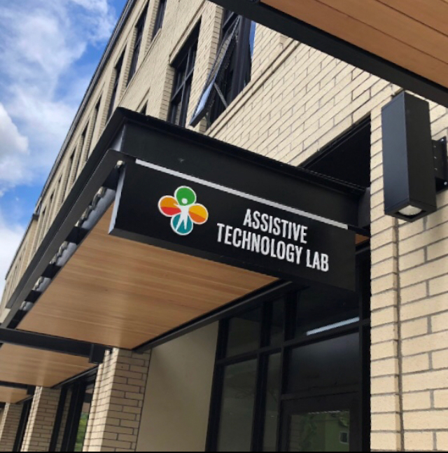 Exterior of building with sign that says "Assistive Technology Lab"
