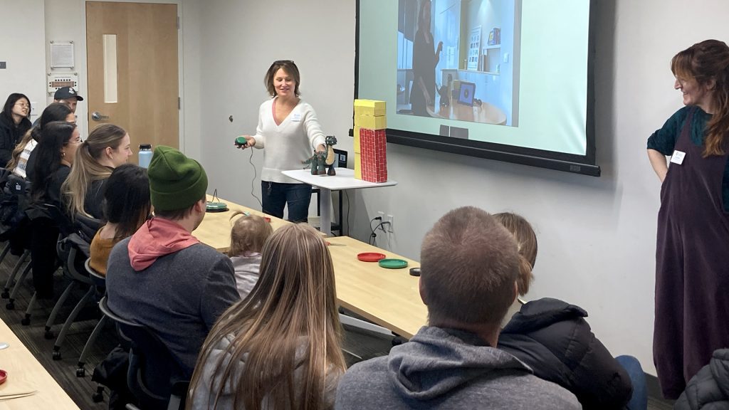 Woman gives presentation in front of group in conference room
