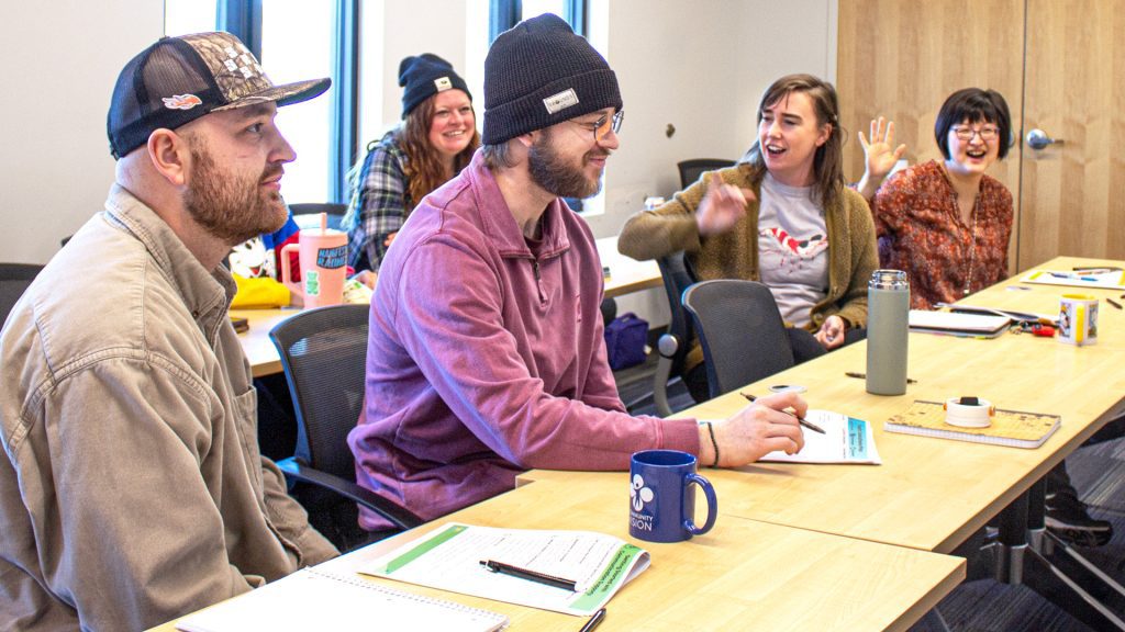 a group of support professionals set at tables during a training