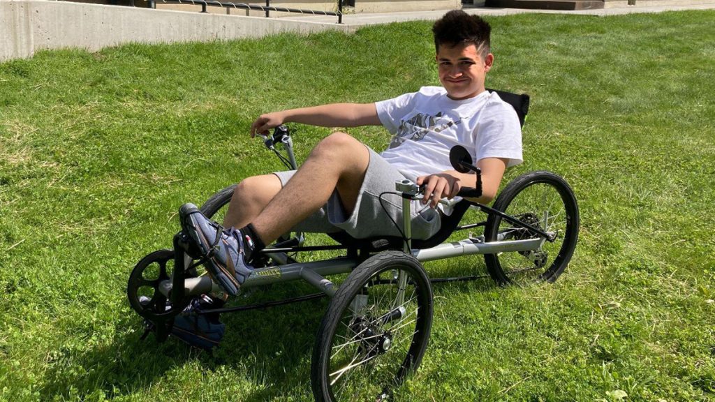 a boy on an adaptive bicycle